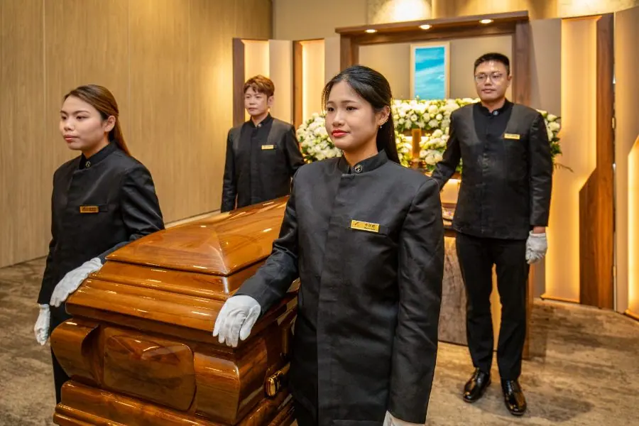 Pallbearers carrying the casket at a Buddhist funeral