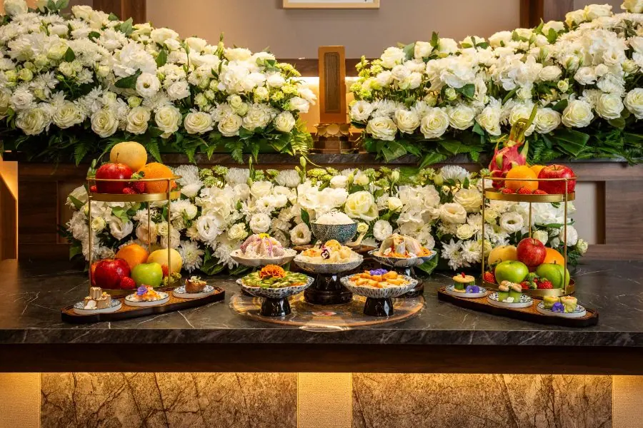 Fresh floral and fruit offerings on a Buddhist altar