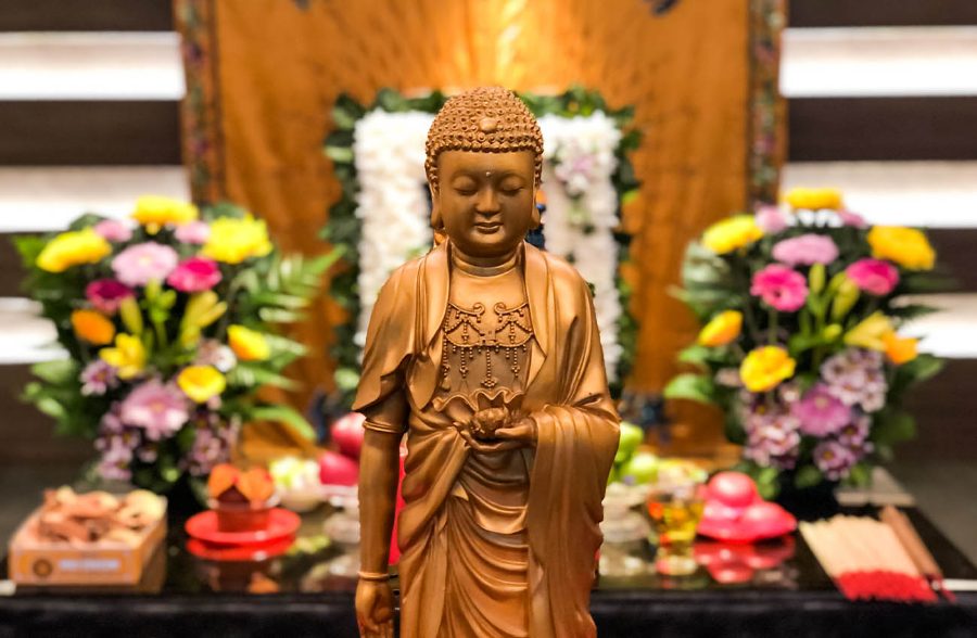 Buddha statue with lotus and offerings at a Buddhist wake